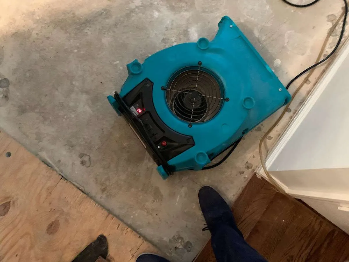 Air mover drying subfloor during Commercial Water Damage Restoration in Mulvane
